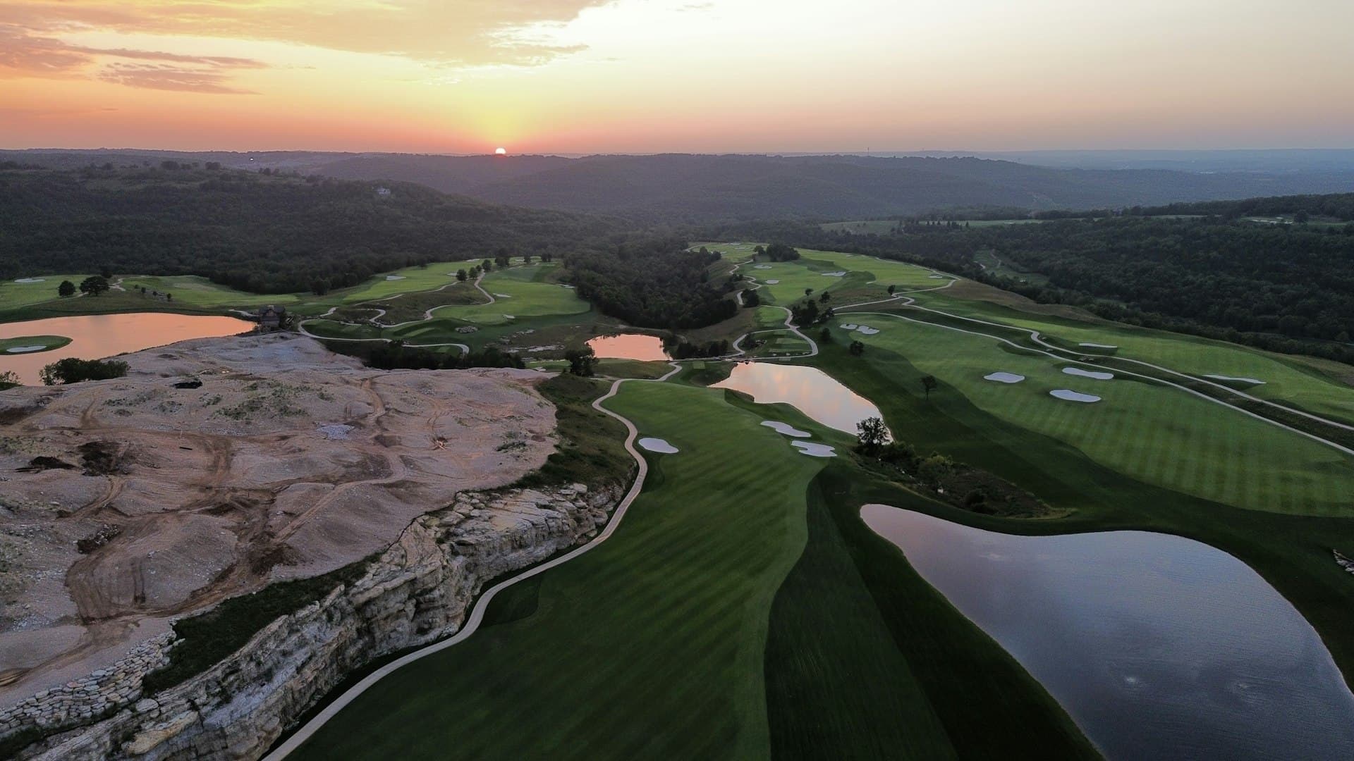 Aerial view of a golf course at sunset